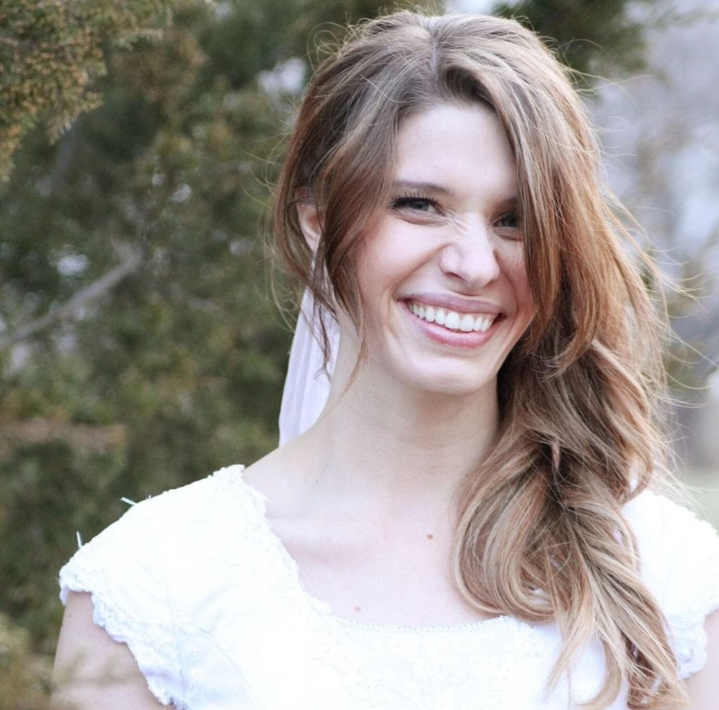 Smiling woman in white dress