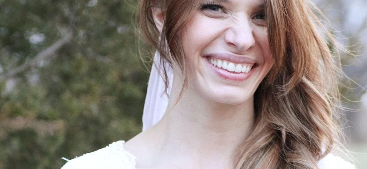 Smiling woman in white dress