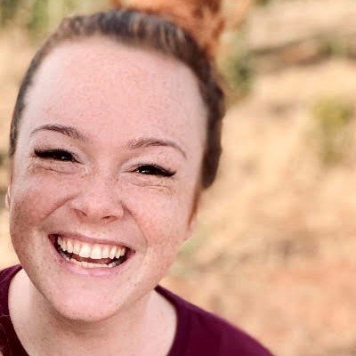 Woman with freckles smiling at the camera