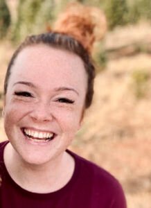 Woman with freckles smiling at camera