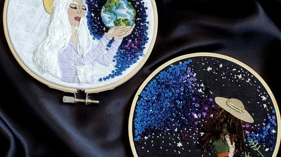 Embroidered Heavenly Mother holding earth and embroidered woman looking at stars.