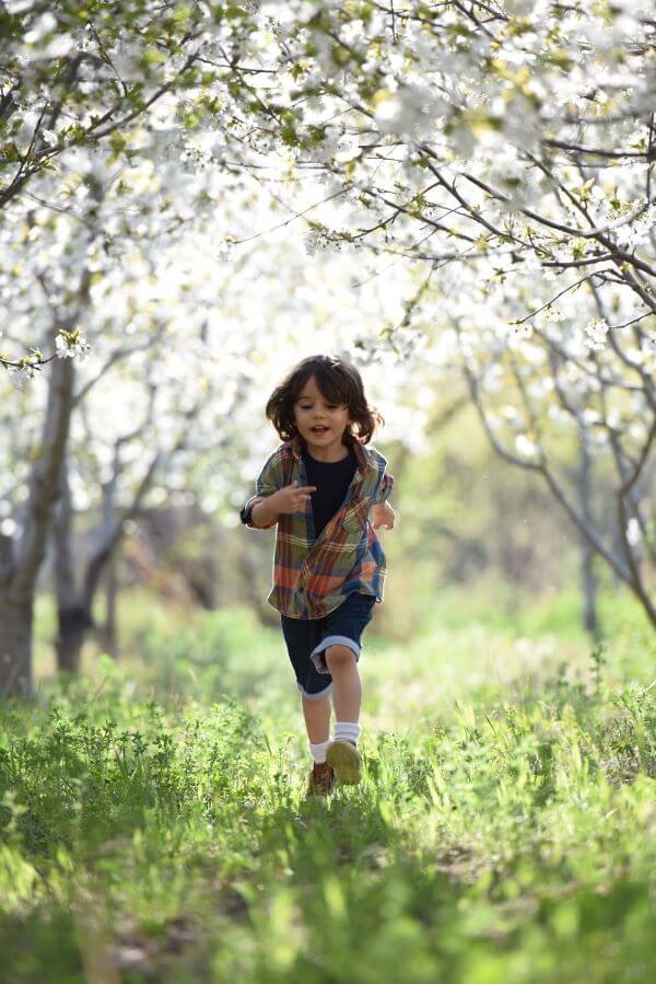 Happy young boy running through or