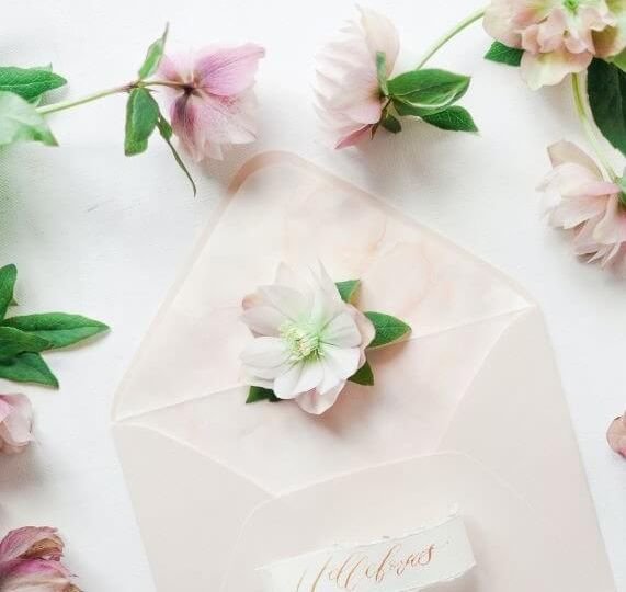 Open envelope surrounded by pink flowers