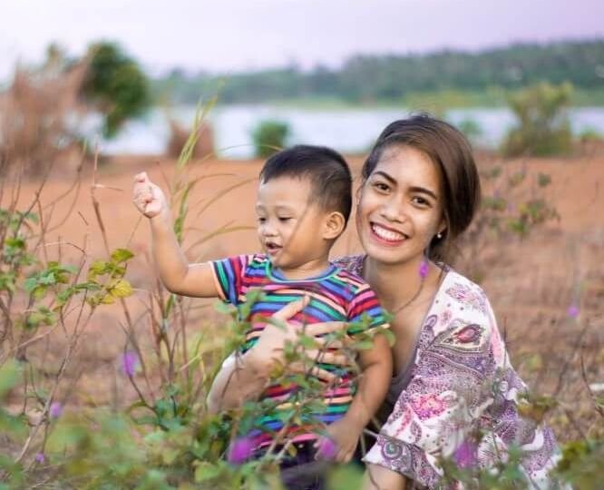 Mother holding child outdoors