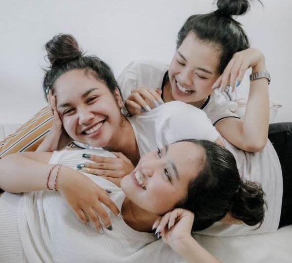 Three sisters laughing